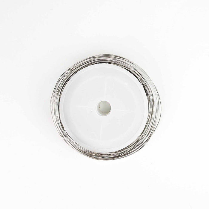 Spool of 18 gauge stainless steel crafting wire on white plastic bobbin