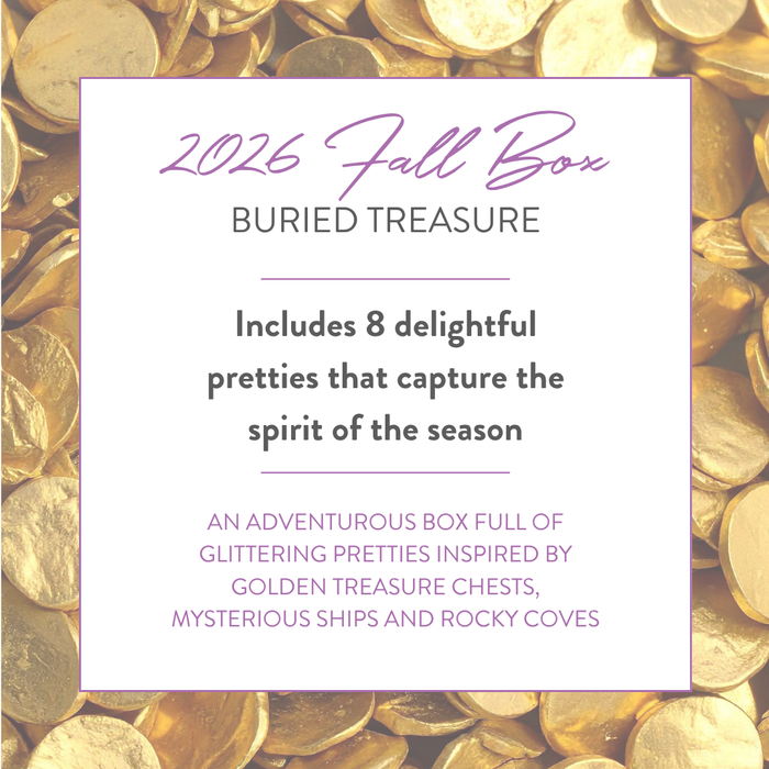 2026 Buried Treasure Fall Box details on a gold coin background: includes 8 delightful pretties inspired by treasure chests, ships and rocky coves