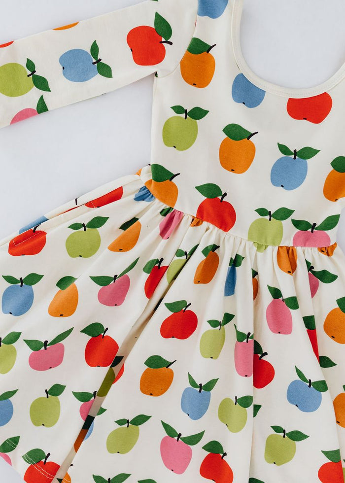 Children's dress with colorful fruit pattern on a white background