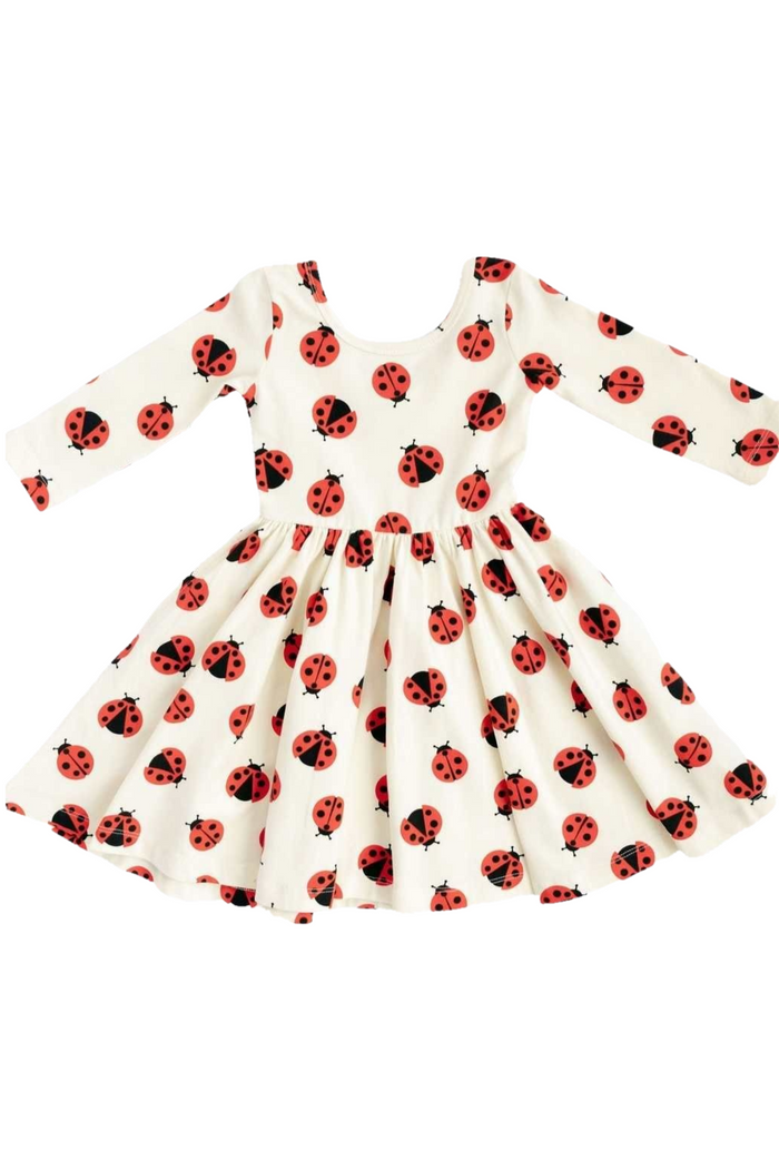 White dress with red and black ladybug pattern on a white background