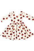 White dress with red and black ladybug pattern on a white background