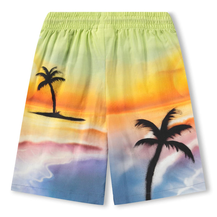 Colorful beach shorts with palm tree design on a white background