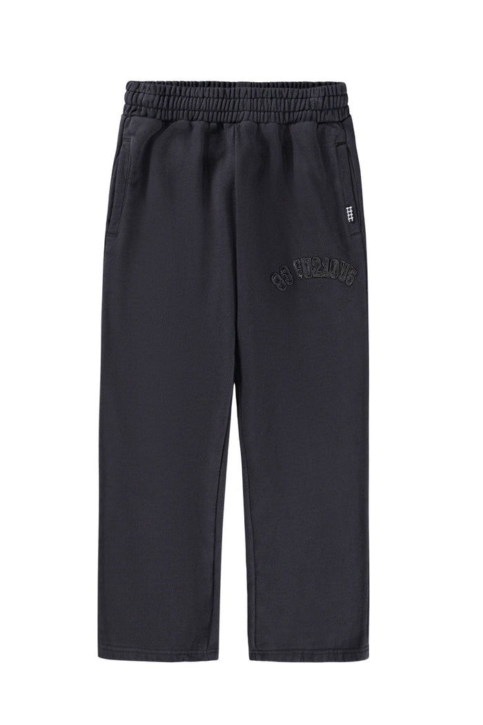 Black pants with a brand logo on a white background