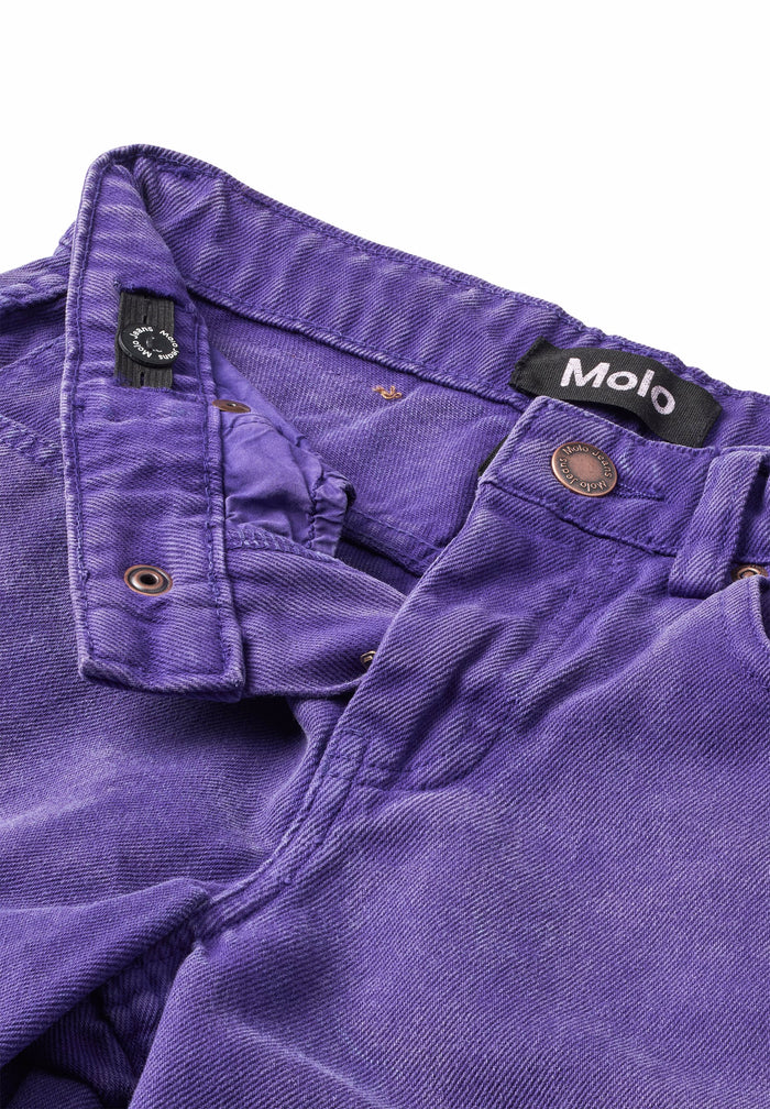 Close-up of purple pants with a brand label on a white background