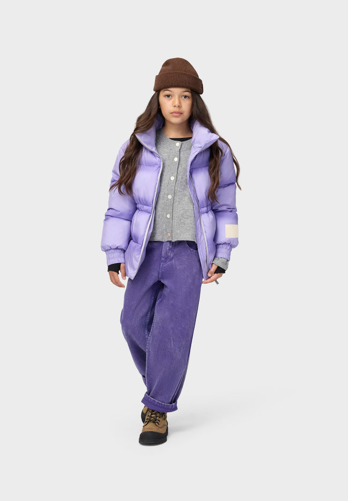 Person wearing a purple puffer jacket and pants on a white background