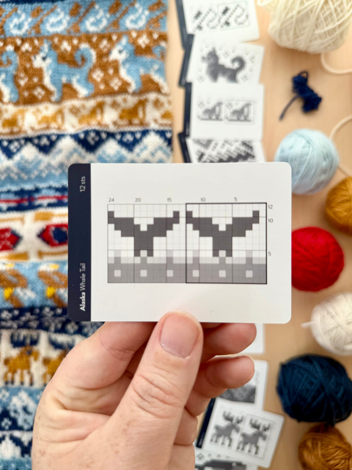 Hand holding an Alaska Doodle whale tail colorwork chart card