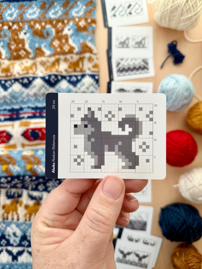 Hand holding an Alaska Doodle Alaskan malamute colorwork chart card