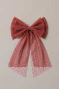 Ruby bow with lace details on a beige background