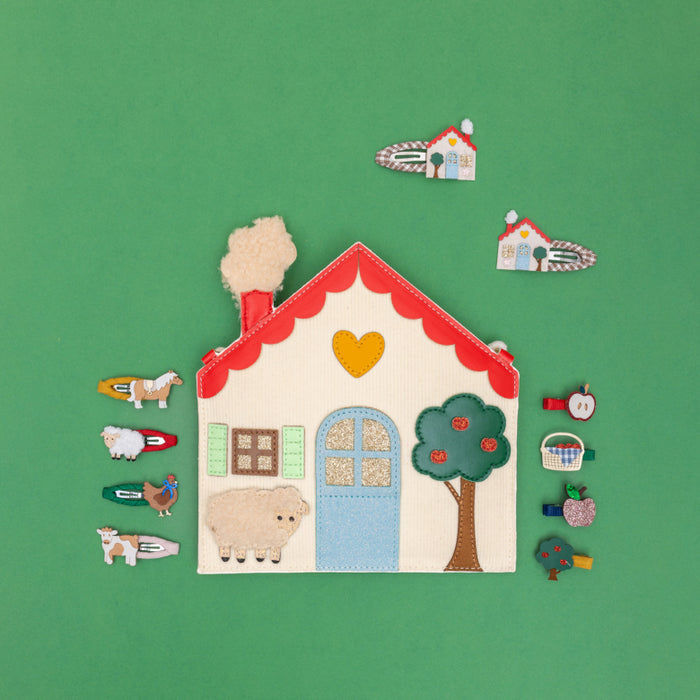 Felt village set with various small houses and animals on a green background