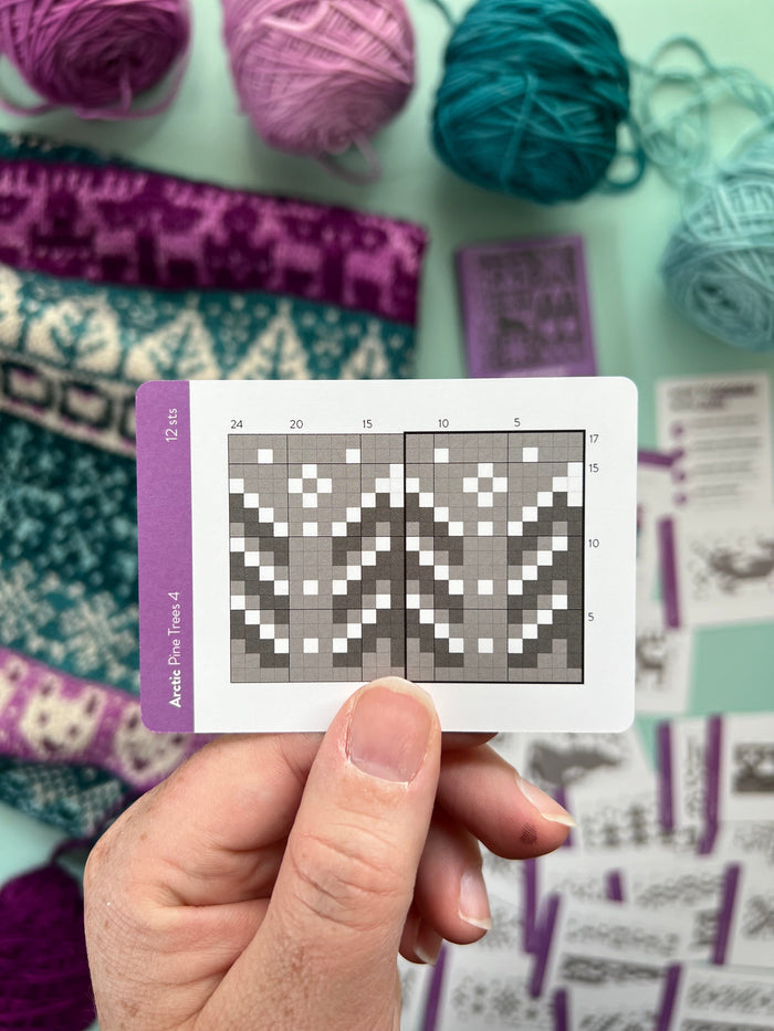 Hand holding an Arctic Doodle pine trees colorwork chart card