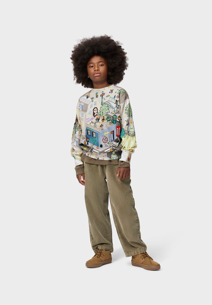 Person wearing a patterned sweater and beige pants on a white background