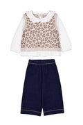 Children's outfit with leopard print top and navy pants on a white background