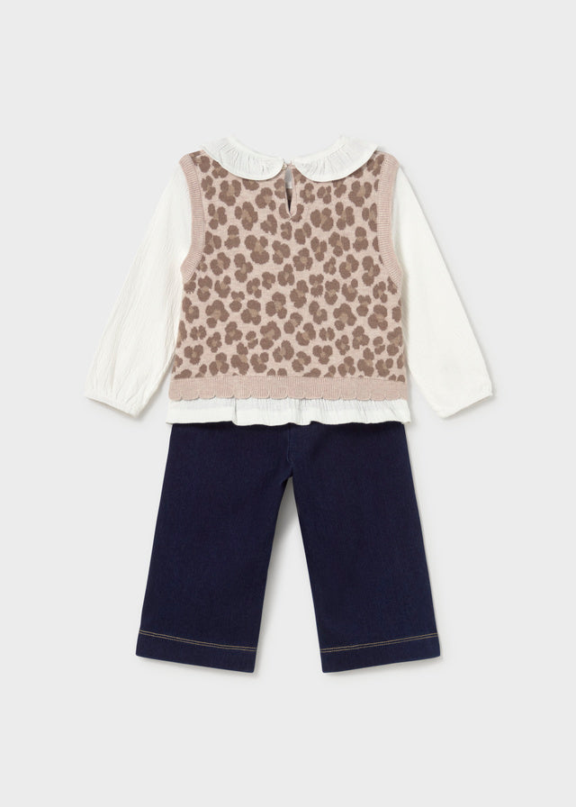 Children's outfit with leopard print top and navy pants on a light gray background