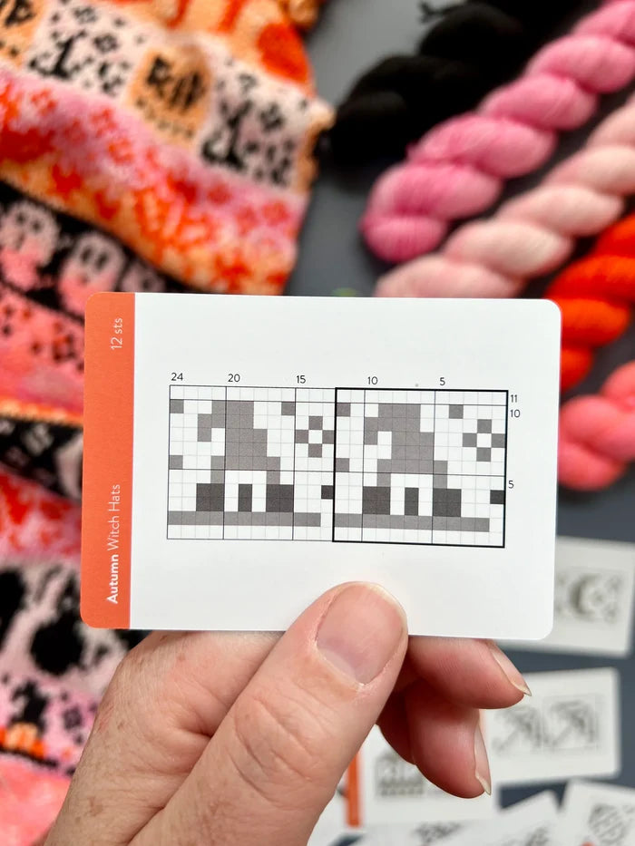 Hand holding an Autumn Doodle witch hat colorwork chart card
