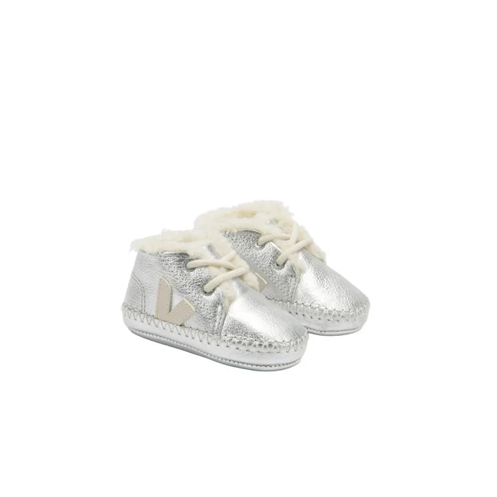 A pair of metallic silver baby booties with white faux-fur lining and white laces, shown on a white background.