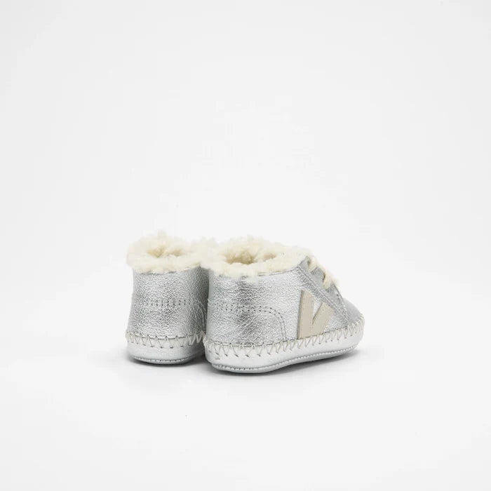 A pair of silver leather baby booties with soft cream shearling lining, shown from the back on a clean white background.