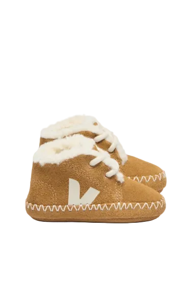 Brown baby booties with white fur lining and a brand logo on a white background