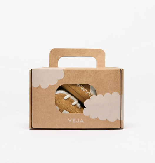 Cardboard box with a sneaker inside, featuring the brand 'Veja', on a white background.