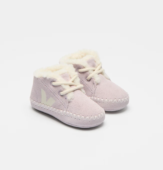 Pair of light purple baby shoes with white laces on a white background