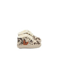 A pair of baby lace-up shoes featuring a brown and beige cow print pattern, white faux-fur trim, and a brown leather logo on the side, set against a plain white background.