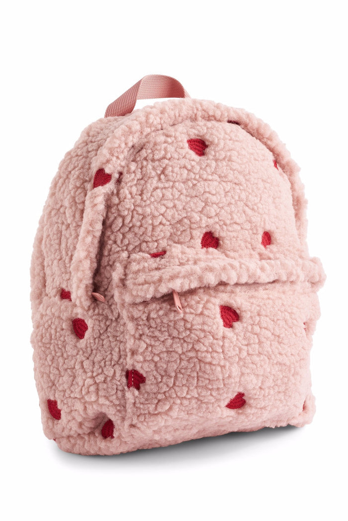 Pink backpack with red heart patterns on a white background