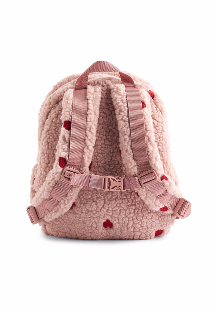 Pink backpack with sherpa texture and red heart details on a white background