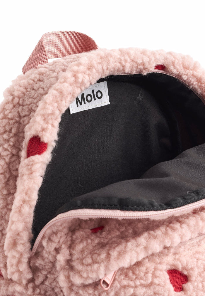 Close-up of a pink fleece-lined product with a Molo label on a white background
