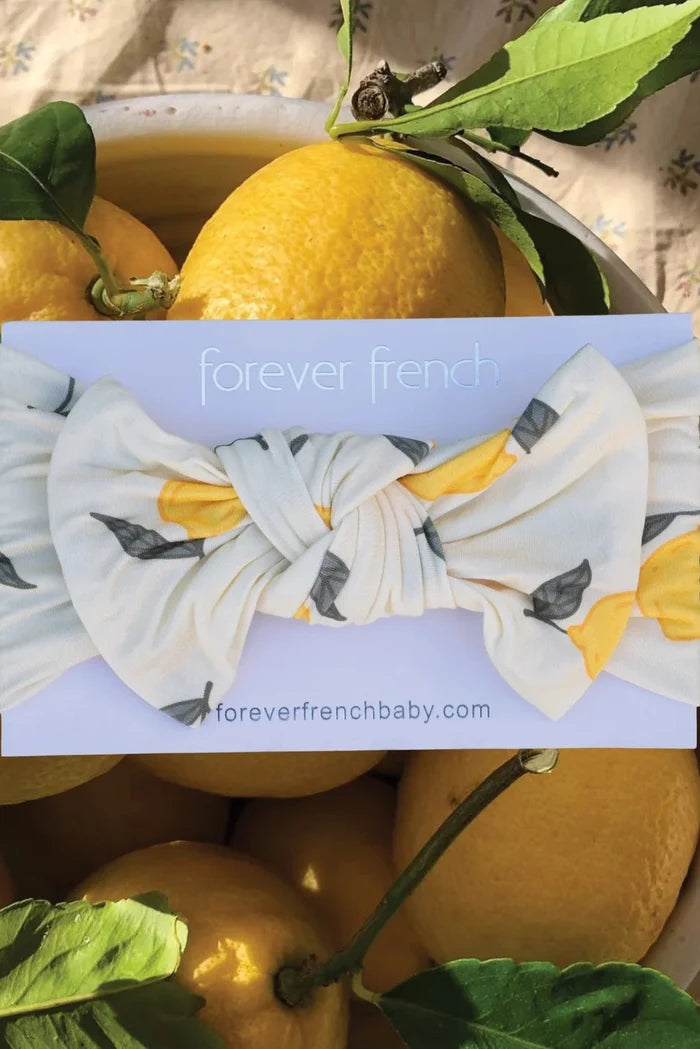 Lemons with a headband featuring lemon design and 'forever french' branding.