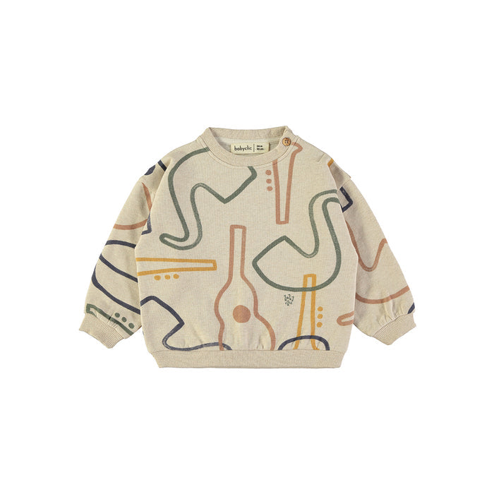 A beige long-sleeve crewneck sweatshirt with an abstract line art pattern in muted orange, green, and navy blue, laid flat on a white background.