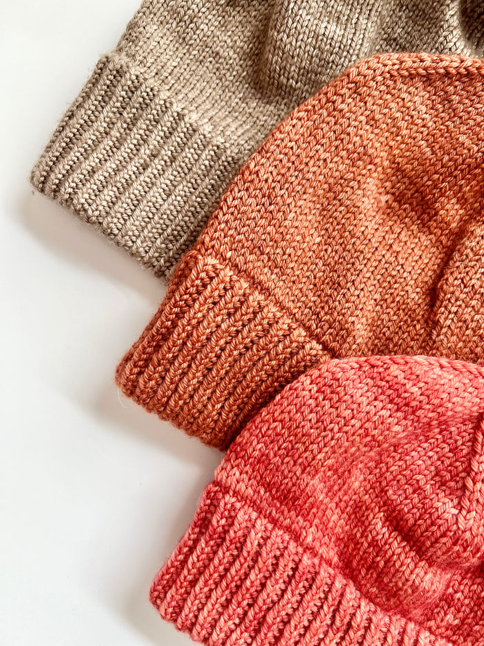 Close-up of the folded ribbed brims on three Base Doodle Beanie 2 hats