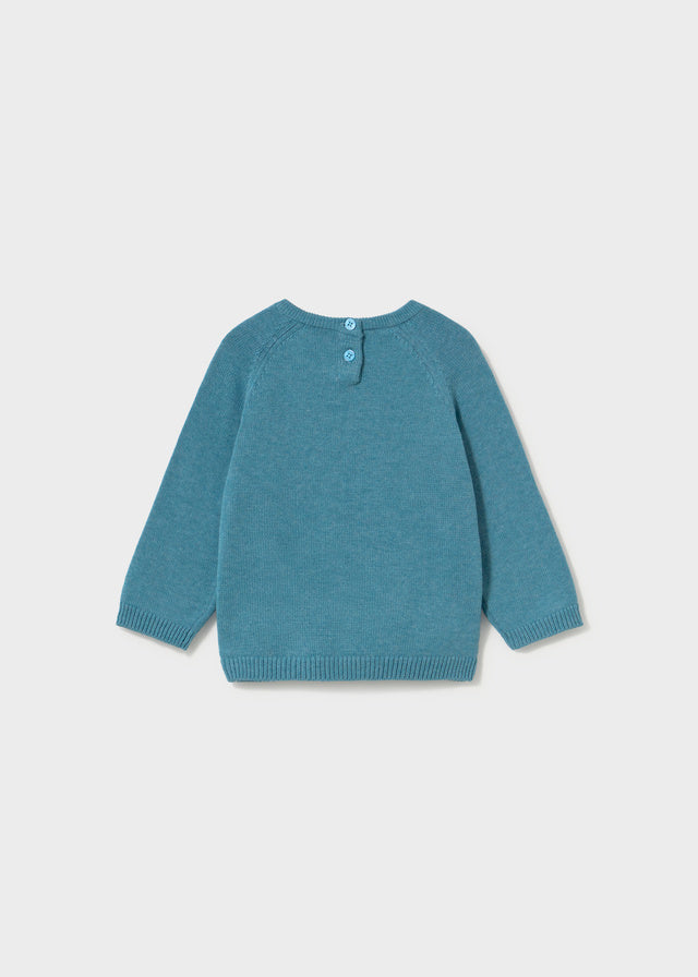 Blue sweater on a light gray background