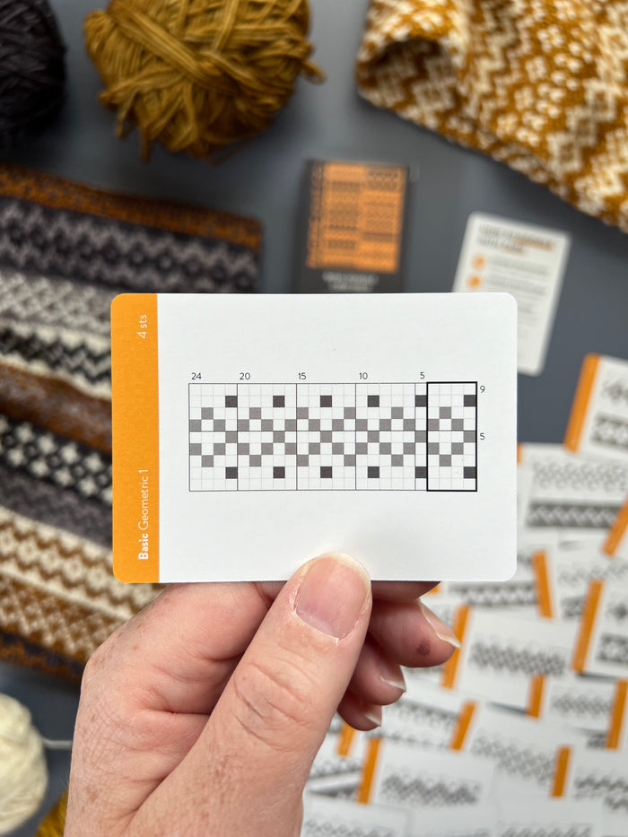 Hand holding a Basic Doodle checkered colorwork chart card