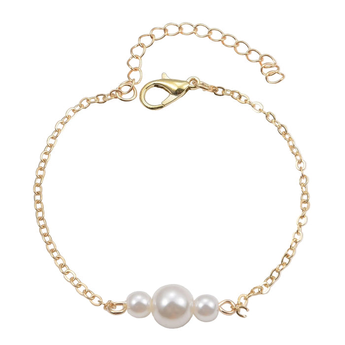 A delicate gold-tone link chain bracelet featuring three graduated white pearls at the center, secured with a lobster claw clasp and adjustable extender chain on a white background.