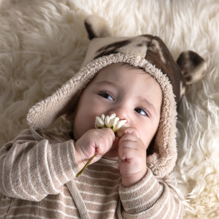 Baby wearing cow print hat