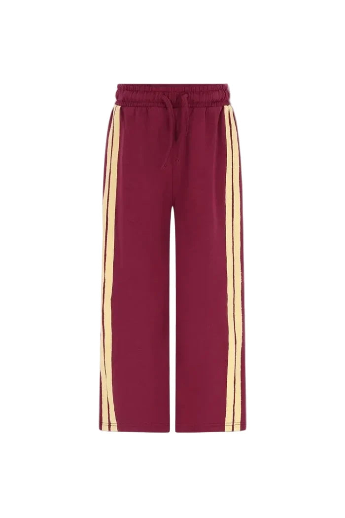 burgundy straight leg sweatpants with  drawstring and 2 pale yellow side stripes on white background
