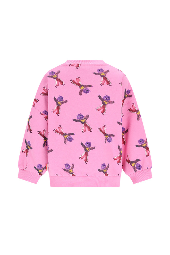 A pink long-sleeve crewneck sweatshirt featuring an allover print of cartoon dancing figures in purple, yellow, and red, shown against a plain white background.