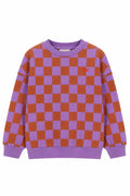 A purple and rust-orange checkered crewneck sweatshirt with a small red embroidered logo on the left chest, displayed on a solid white background.