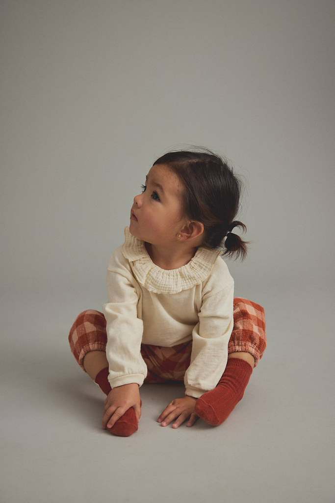 Child wearing gingham pants