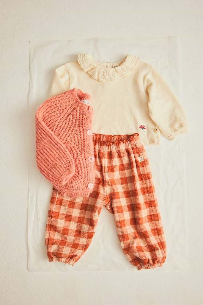 flat lay of baby outfit with gingham pants