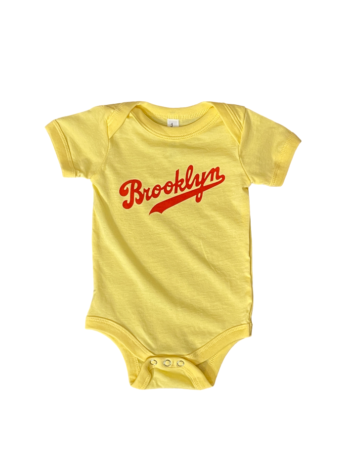 yellow baby onesie with red Brooklyn baseball font logo