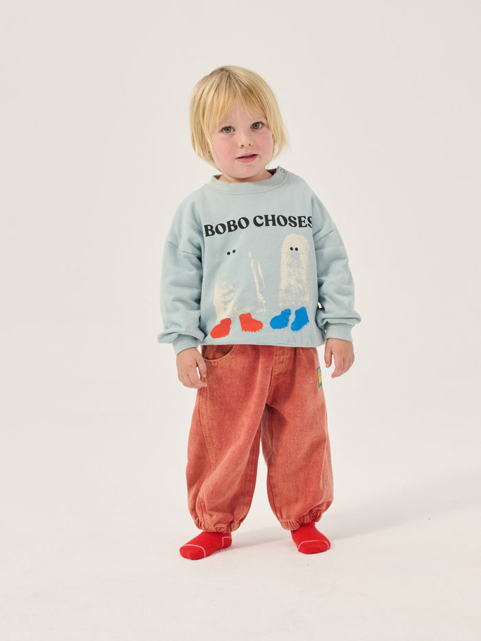 child wearing Bobo Choses sweatshirt with ghosts