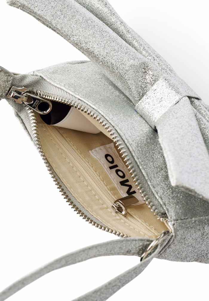 Close-up of a gray handbag with a bow detail, Moio brand visible.