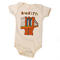 Baby onesie with Brooklyn Bridge graphic and 'Brooklyn' text on a white background