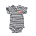 A striped organic cotton baby onesie with a 'Brooklyn, N.Y.' embroidered patch on the front.