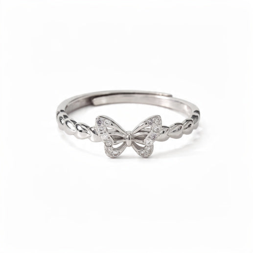 A polished sterling silver adjustable ring featuring a crystal-pavé butterfly centerpiece with a twisted band, centered on a pure white background.