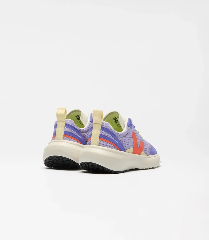 A pair of children's sneakers shown from the back, featuring a lavender mesh upper with purple and orange stripes, a cream midsole, and a lime green interior lining, set against a plain white background.