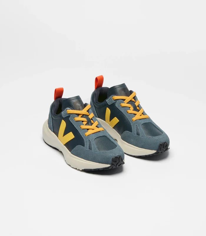 Pair of blue children's sneakers with yellow accents on a white background