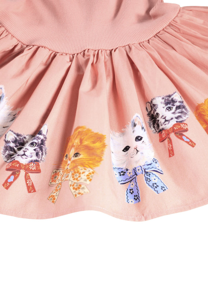Pink dress with cat illustrations and colorful bows on a white background