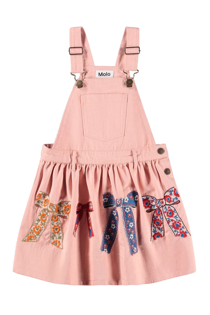 Pink pinafore dress with decorative bows on a white background