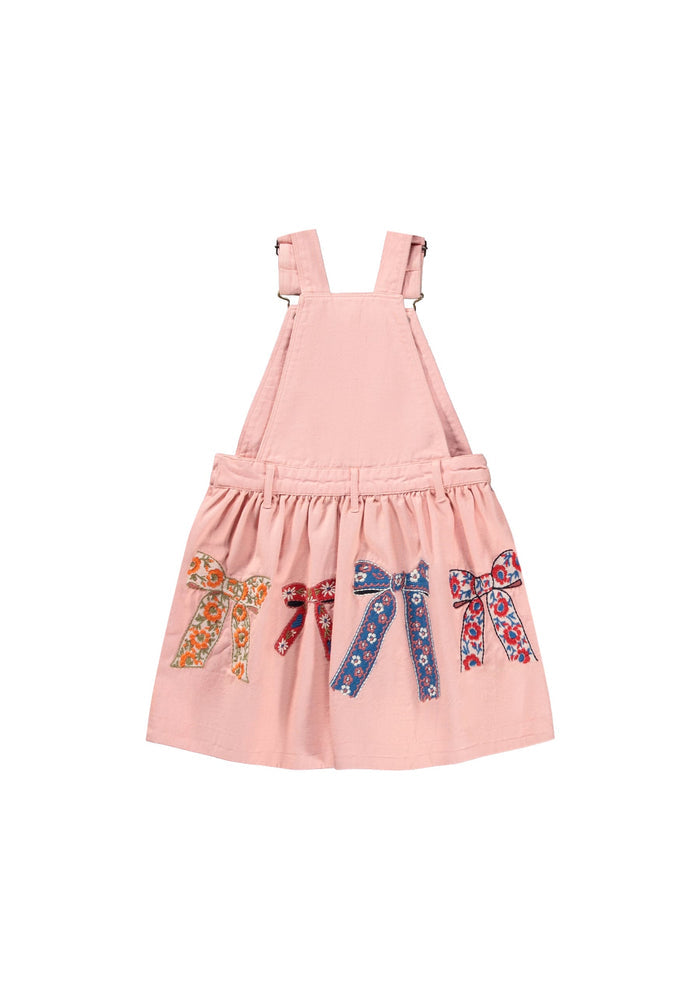 Pink pinafore dress with embroidered bows on a white background